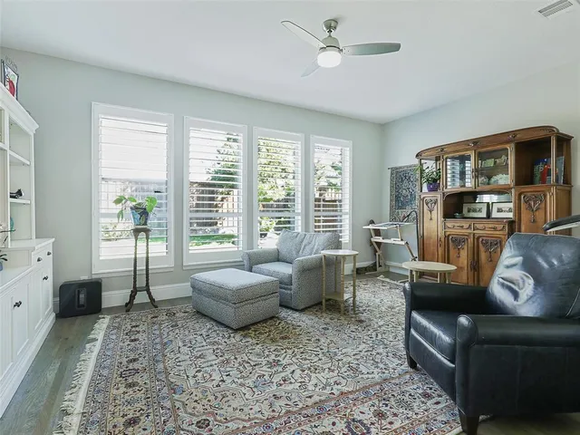 a living room with furniture and large windows