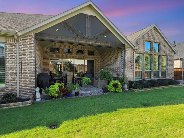a front view of a house with a garden and plants