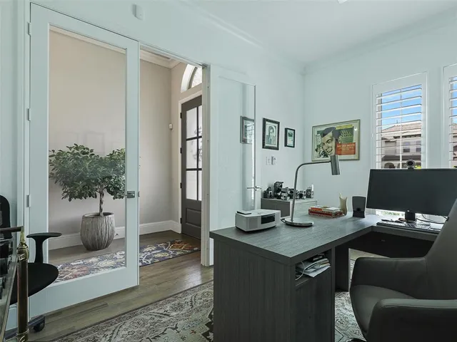 a view of a workspace with furniture and a potted plant