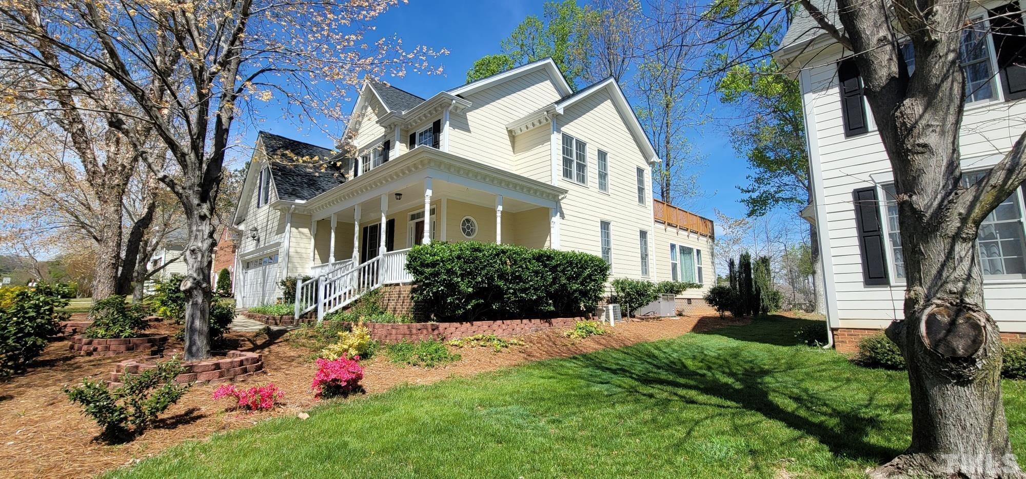303 Evans Estates Drive Cary, NC 27513 - Photo 13 of 61 a front view of a house with a yard and fountain