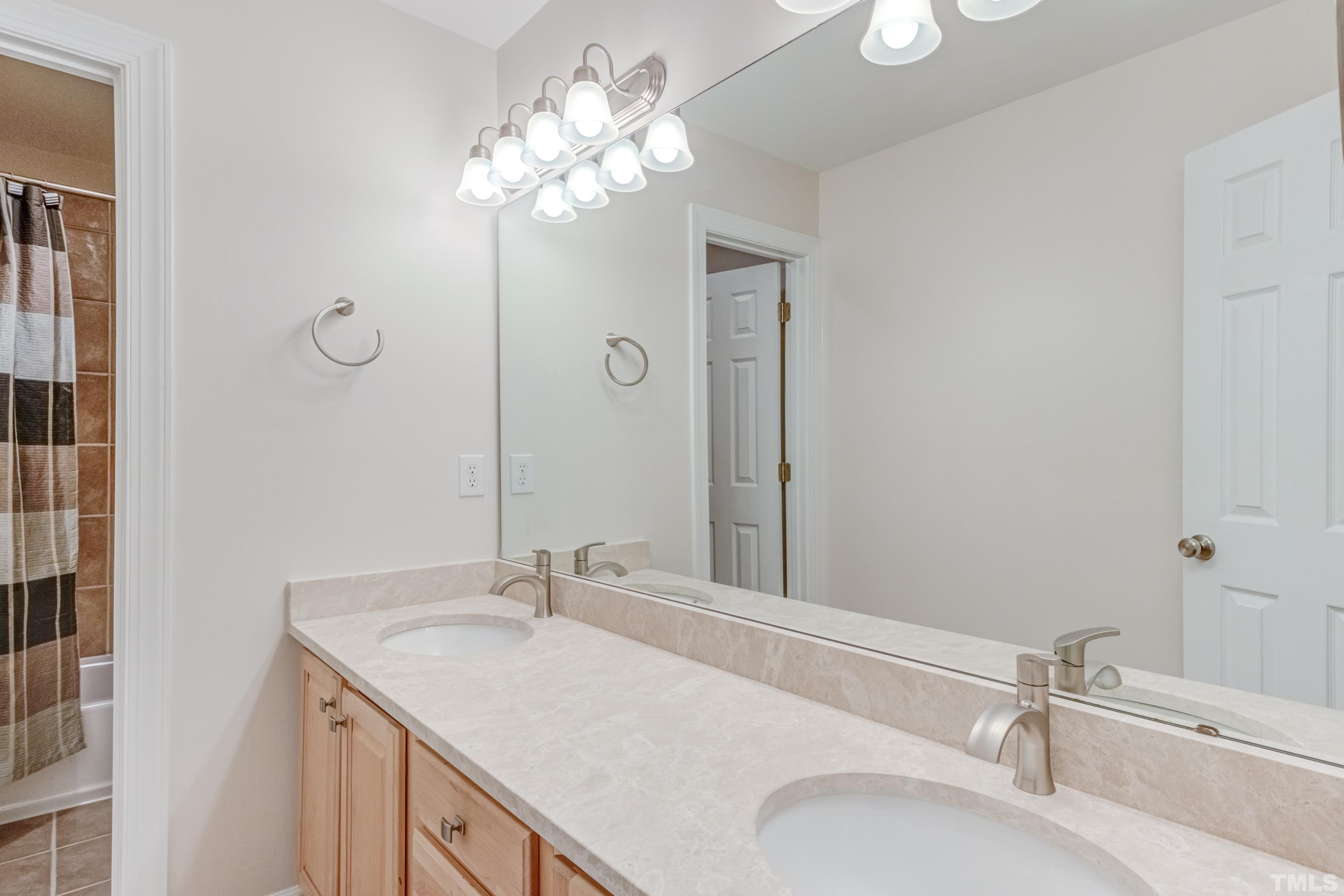 303 Evans Estates Drive Cary, NC 27513 - Photo 34 of 61 a bathroom with a sink vanity granite and a mirror