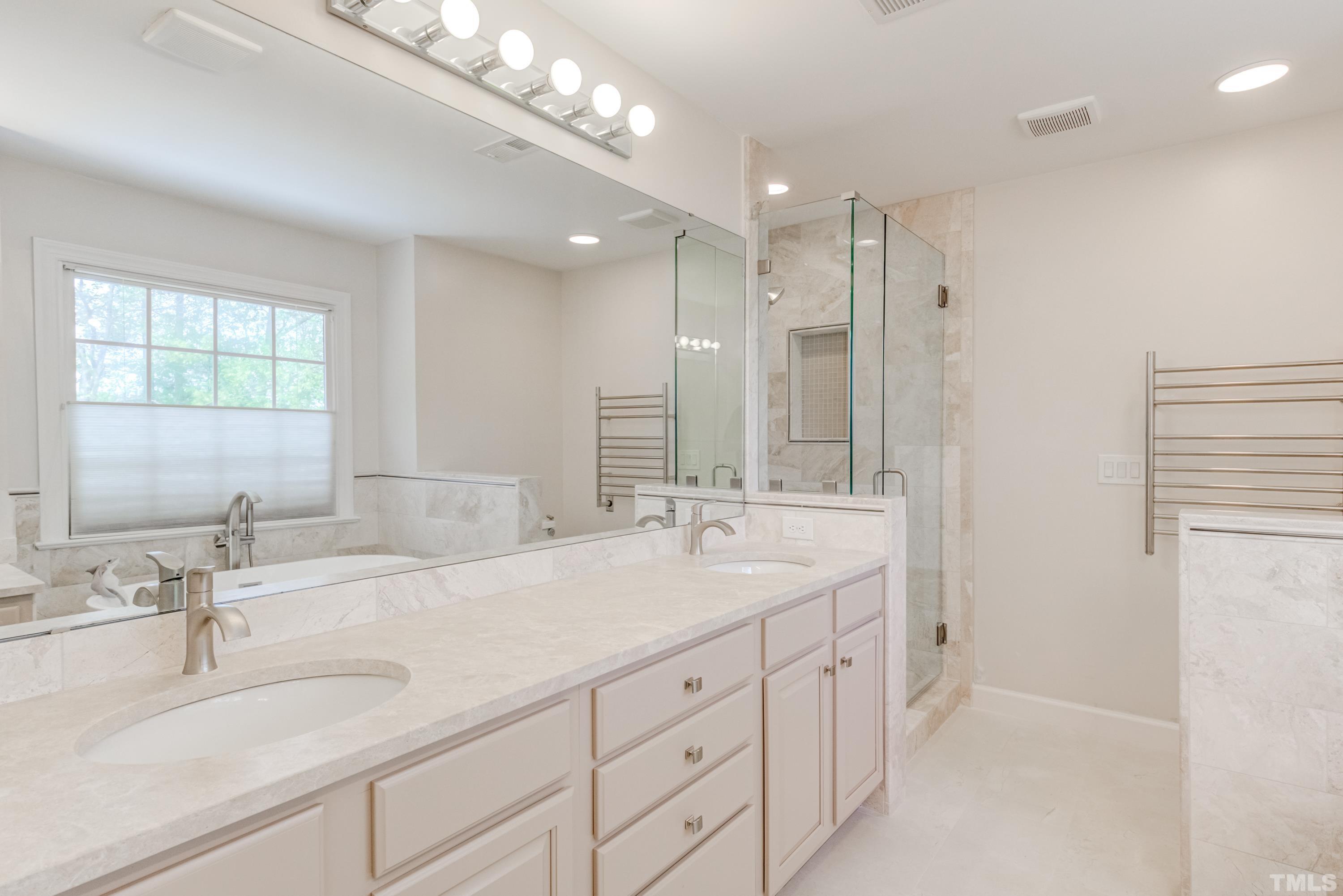 303 Evans Estates Drive Cary, NC 27513 - Photo 39 of 61 a bathroom with double sink and a mirror