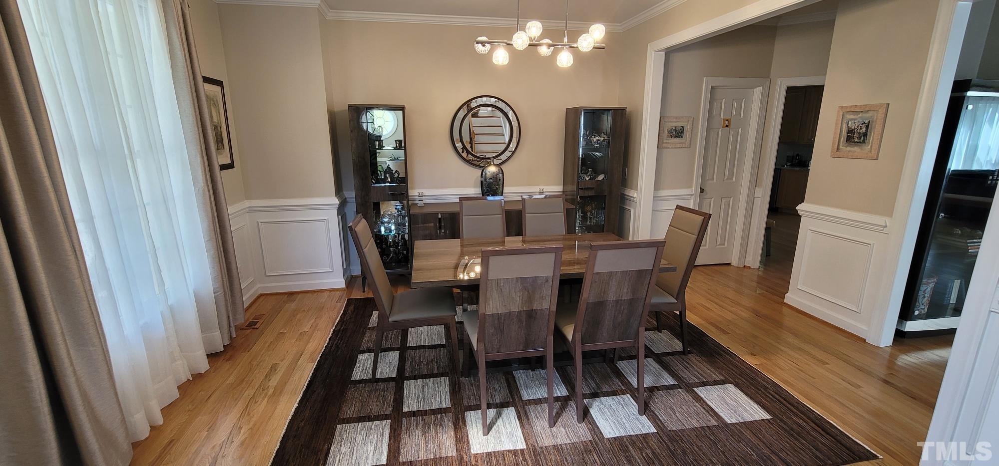 303 Evans Estates Drive Cary, NC 27513 - Photo 4 of 61 a view of a dining room with furniture and wooden floor