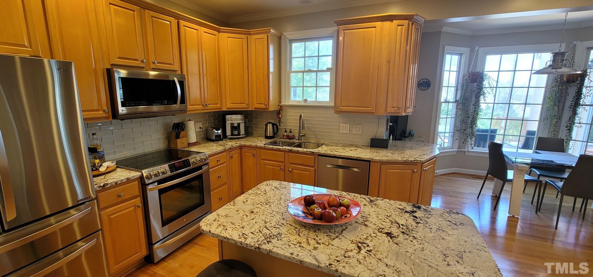 303 Evans Estates Drive Cary, NC 27513 - Photo 5 of 61 a kitchen with stainless steel appliances granite countertop a sink stove and refrigerator