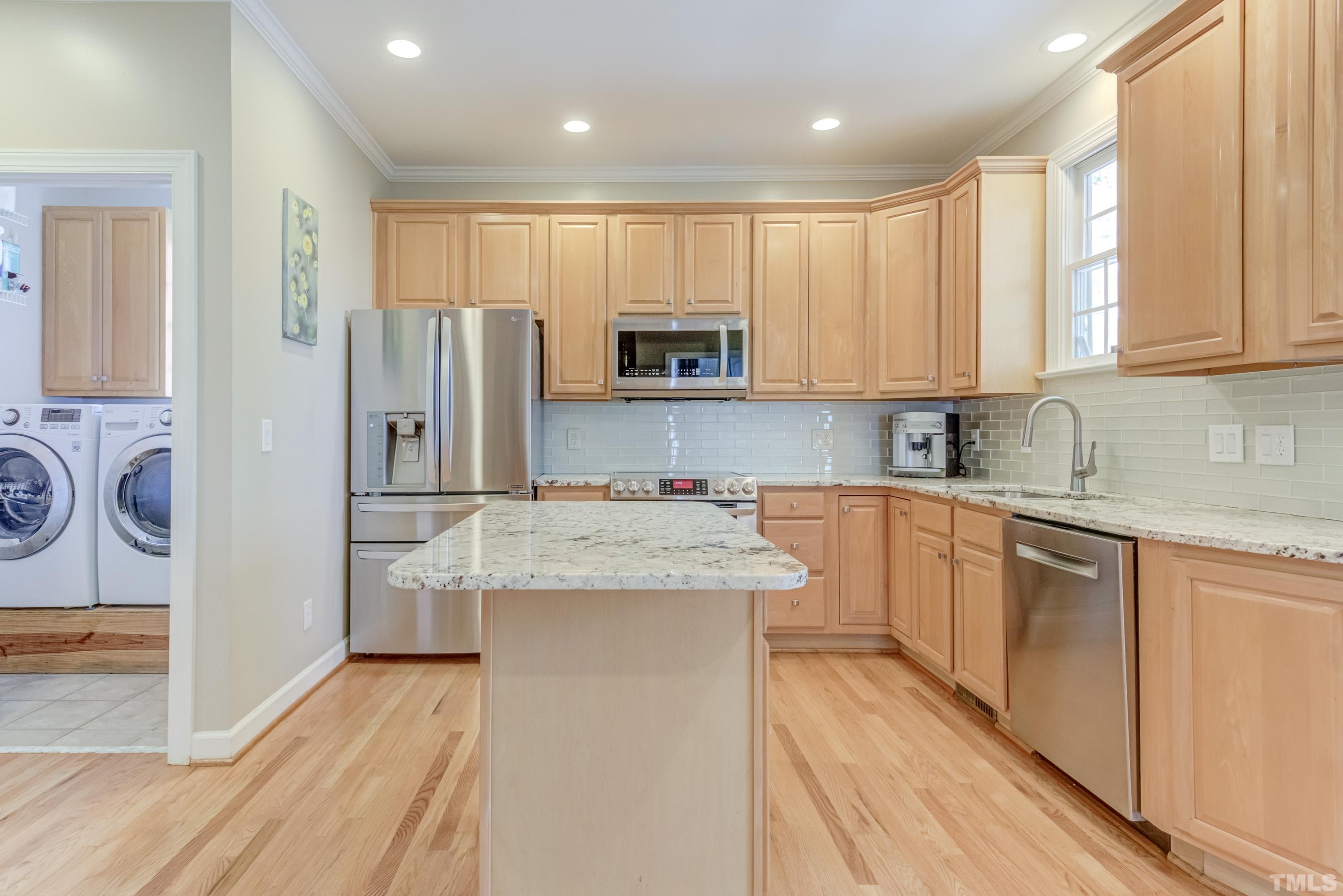 303 Evans Estates Drive Cary, NC 27513 - Photo 52 of 61 a kitchen with stainless steel appliances granite countertop a stove a sink and a refrigerator