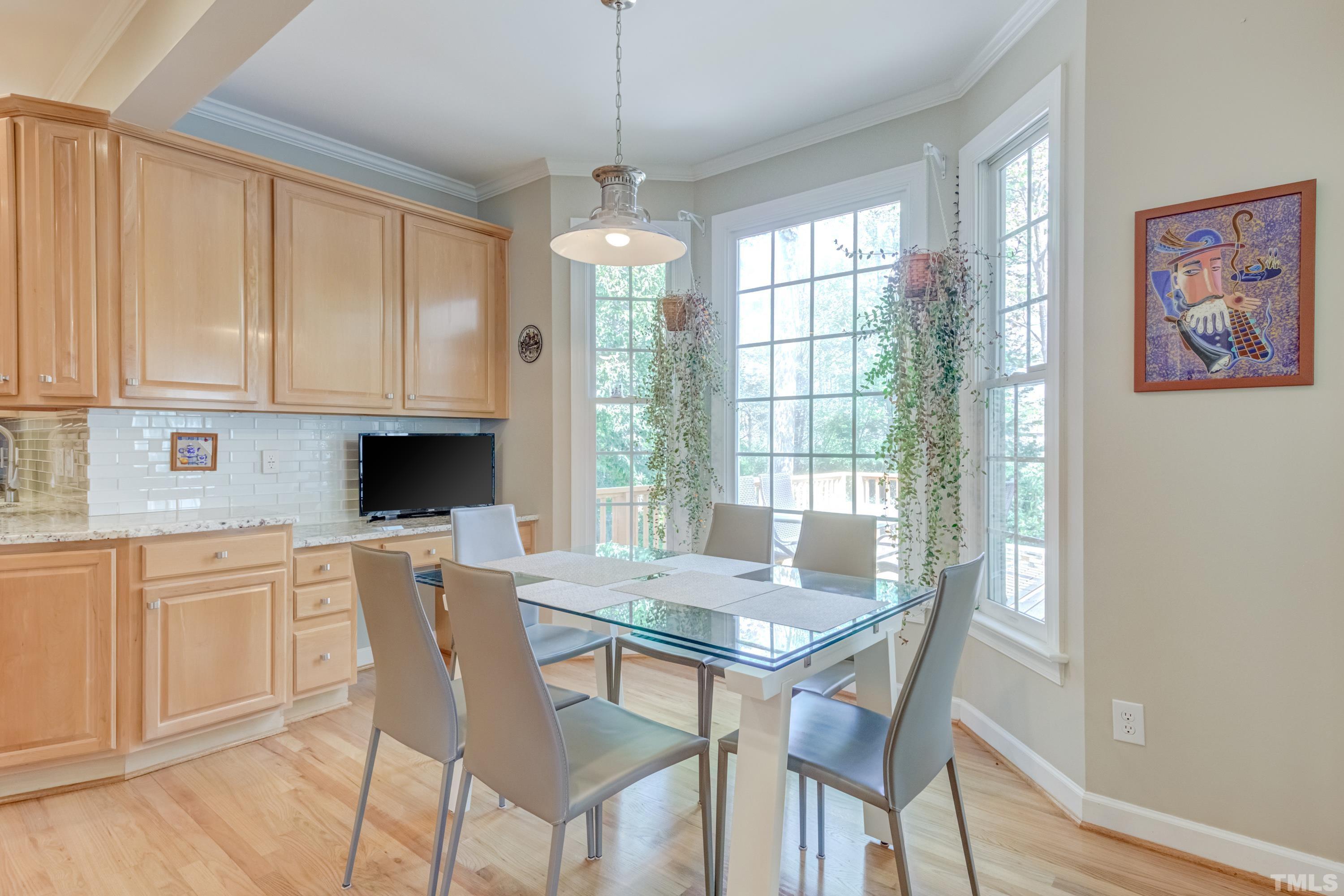 303 Evans Estates Drive Cary, NC 27513 - Photo 56 of 61 a view of a dining room with furniture window and wooden floor