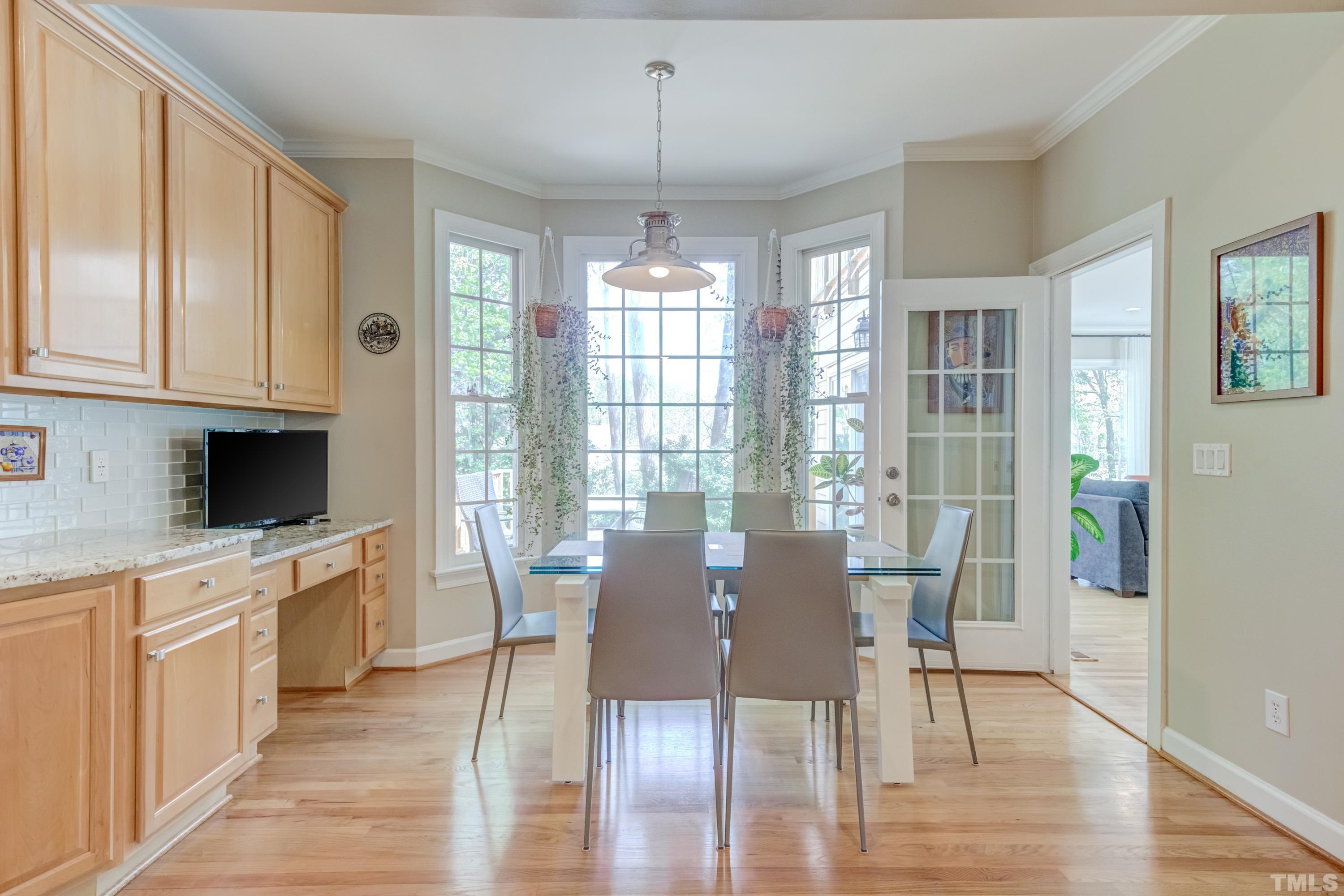 303 Evans Estates Drive Cary, NC 27513 - Photo 57 of 61 a view of a dining room with furniture window and wooden floor