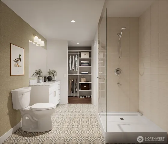 a bathroom with a toilet and a shower