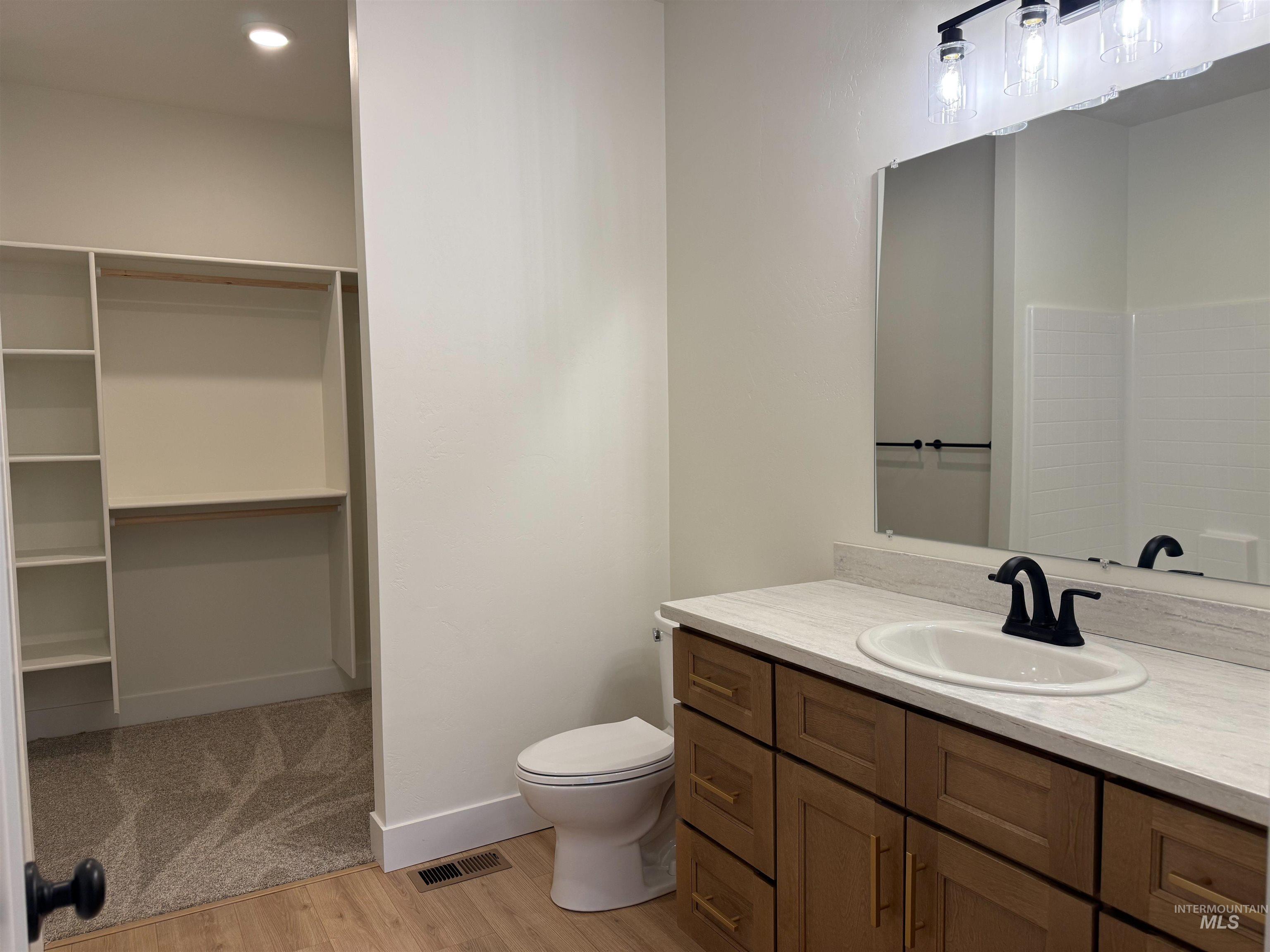 245 Whitman Street Albion, ID 83311 - Photo 11 of 15 Full bathroom with vanity, light wood-type flooring, recessed lighting, and a spacious closet