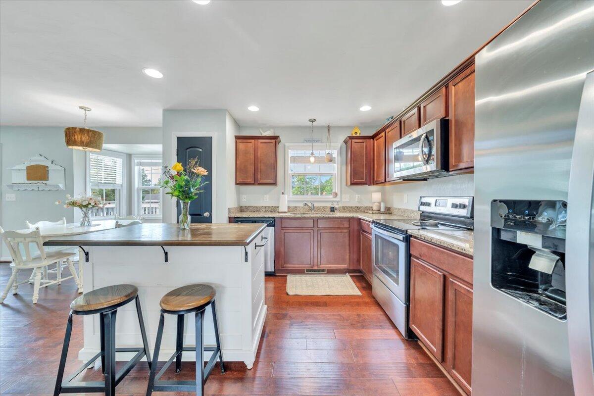 522 Cambridge Ct Road Vinton, VA 24179 - Photo 11 of 43 a kitchen with stainless steel appliances granite countertop wooden cabinets a sink and dishwasher a stove top oven with wooden floor