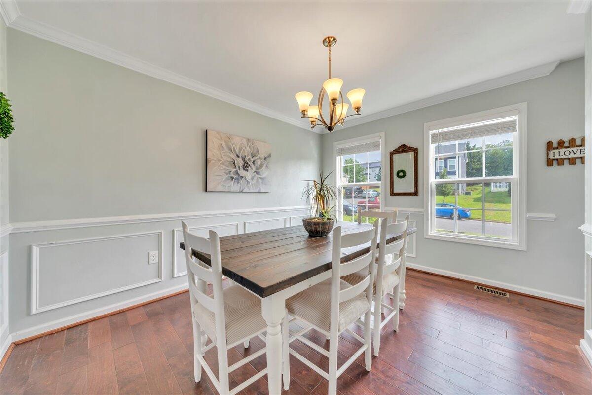 522 Cambridge Ct Road Vinton, VA 24179 - Photo 14 of 43 a view of a dining room with furniture a chandelier and wooden floor