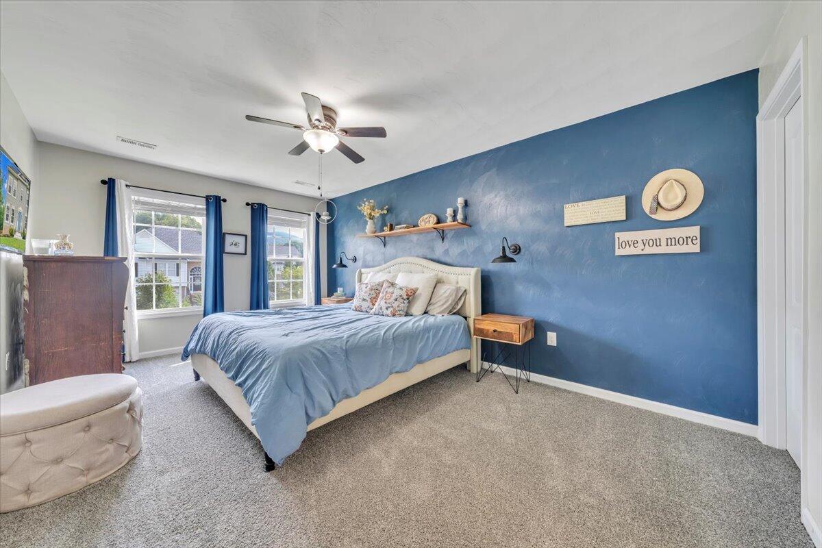 522 Cambridge Ct Road Vinton, VA 24179 - Photo 23 of 43 a bedroom with a bed and a chandelier