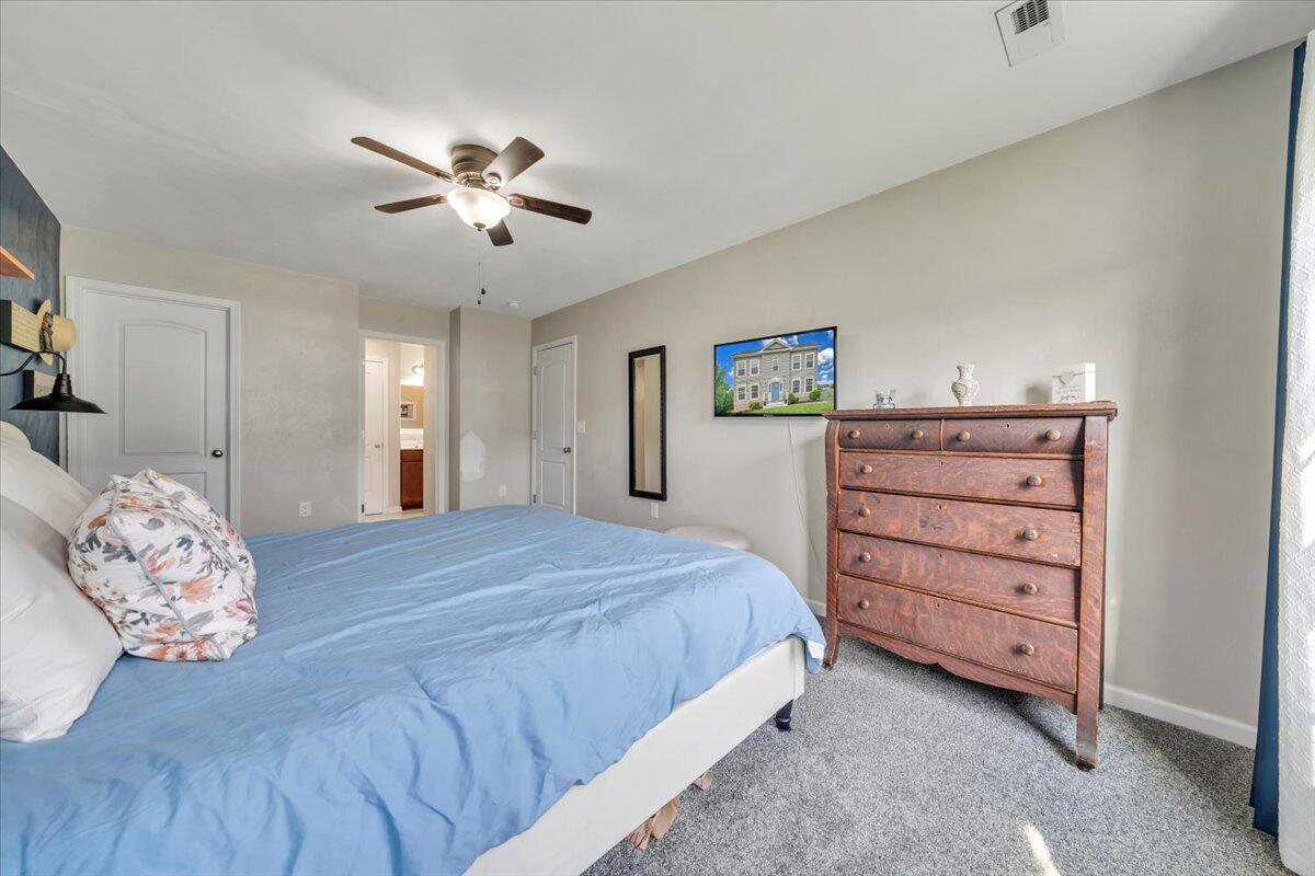 522 Cambridge Ct Road Vinton, VA 24179 - Photo 25 of 43 a bedroom with a bed and a chandelier