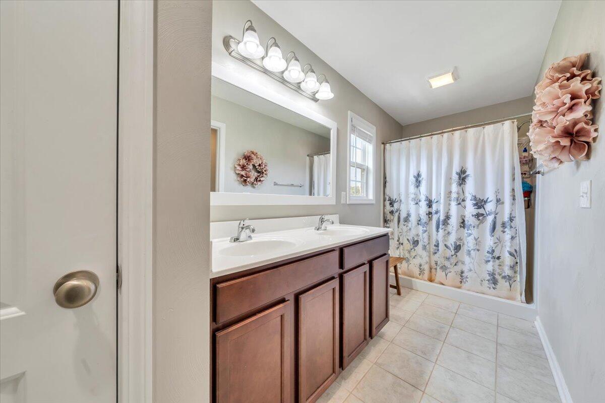 522 Cambridge Ct Road Vinton, VA 24179 - Photo 28 of 43 a bathroom with a double vanity sink mirror and shower