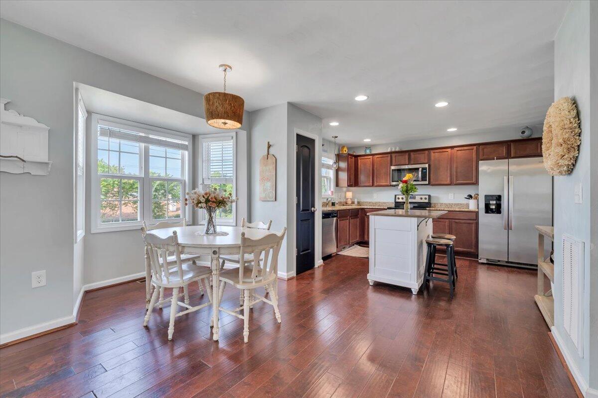 522 Cambridge Ct Road Vinton, VA 24179 - Photo 5 of 43 a view of a dining room and livingroom with furniture wooden floor a chandelier