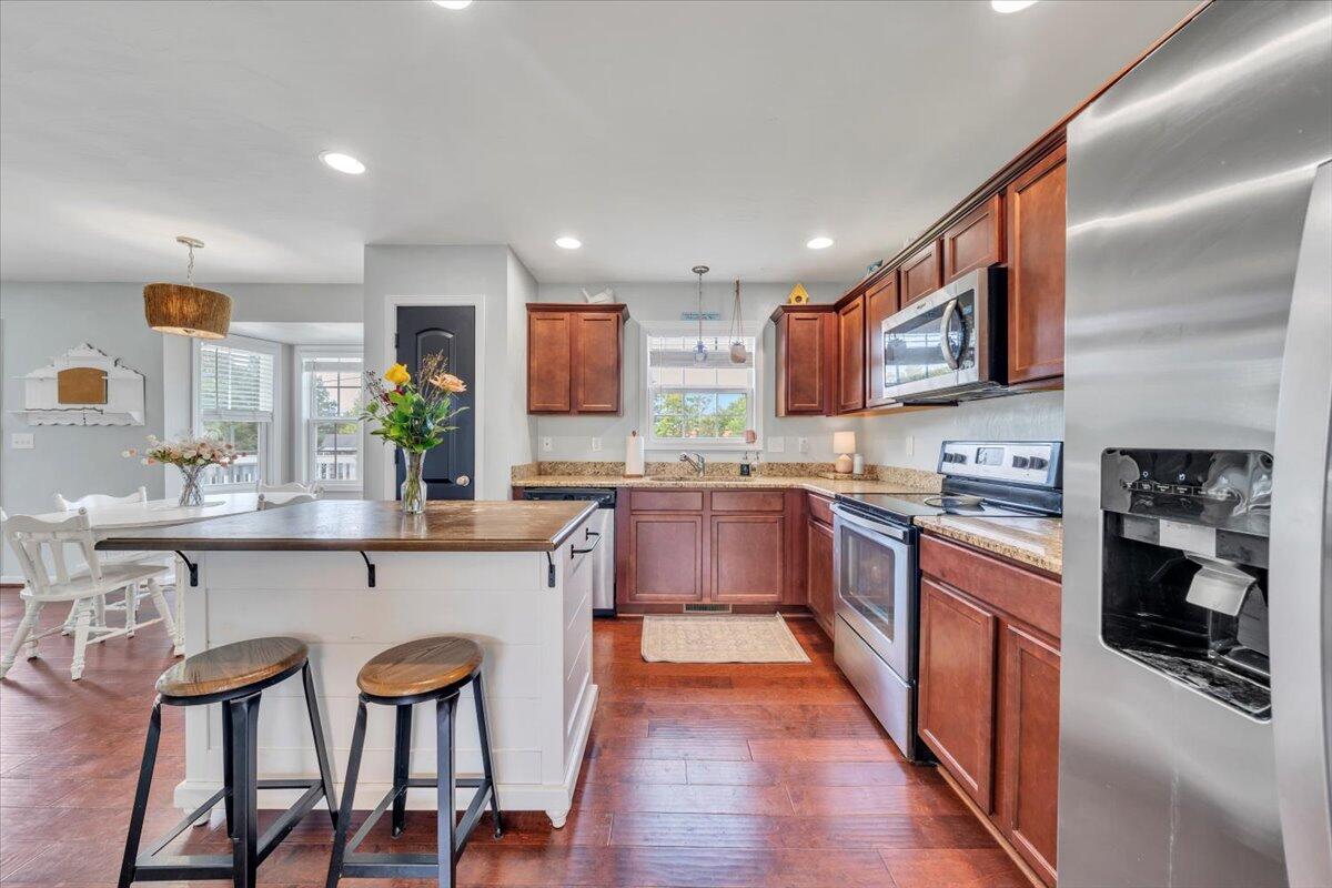522 Cambridge Ct Road Vinton, VA 24179 - Photo 10 of 43 a kitchen with stainless steel appliances granite countertop wooden cabinets a sink and dishwasher a stove top oven with wooden floor