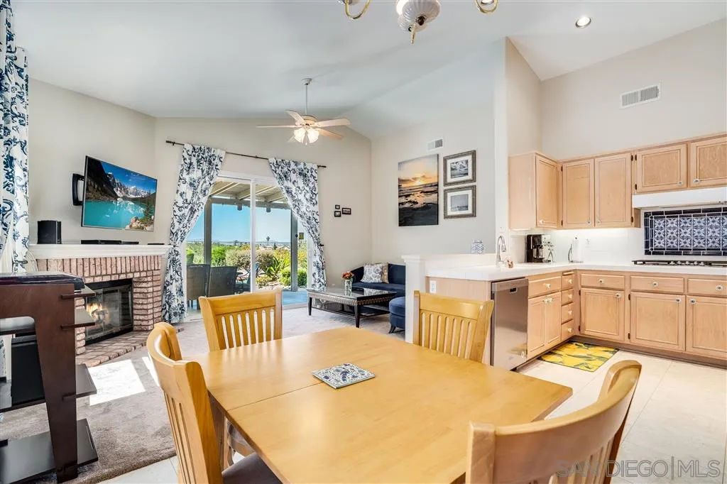 7570 Windy Ridge Road San Diego, CA 92126 - Photo 14 of 25 a large kitchen with cabinets table and chairs