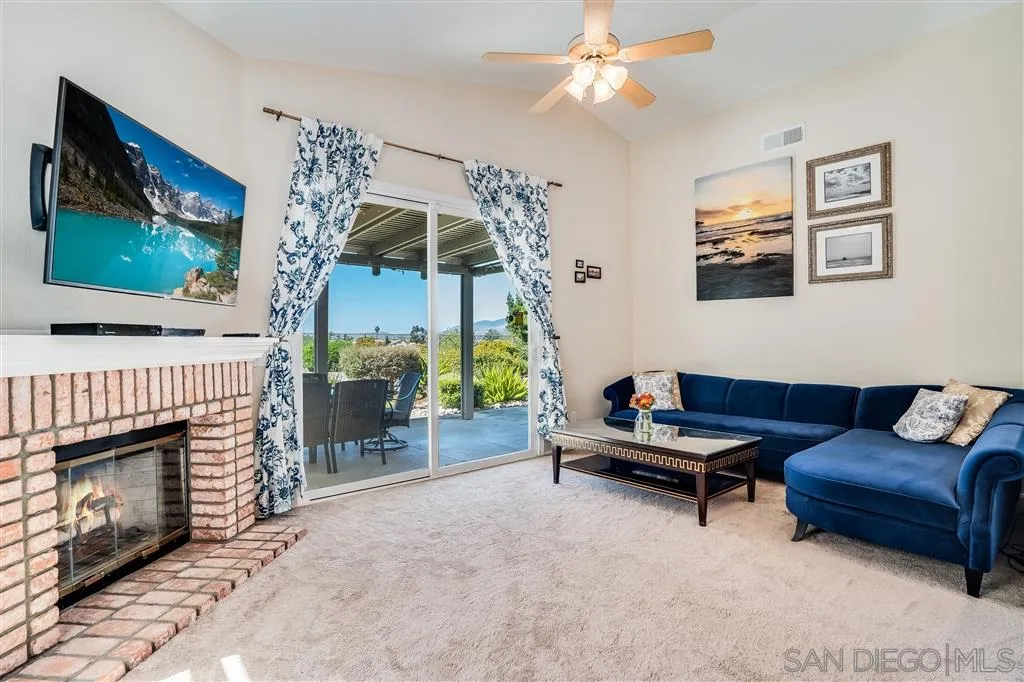 7570 Windy Ridge Road San Diego, CA 92126 - Photo 15 of 25 a living room with furniture and a fireplace