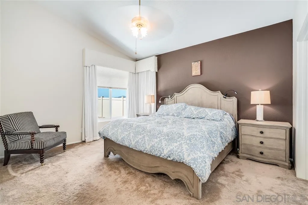 7570 Windy Ridge Road San Diego, CA 92126 - Photo 20 of 25 a bedroom with a bed and a chair