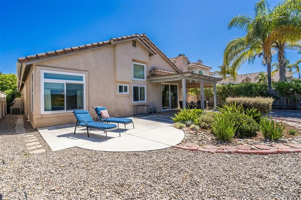 7570 Windy Ridge Road San Diego, CA 92126 - Photo 21 of 25 a view of a house with backyard and sitting area