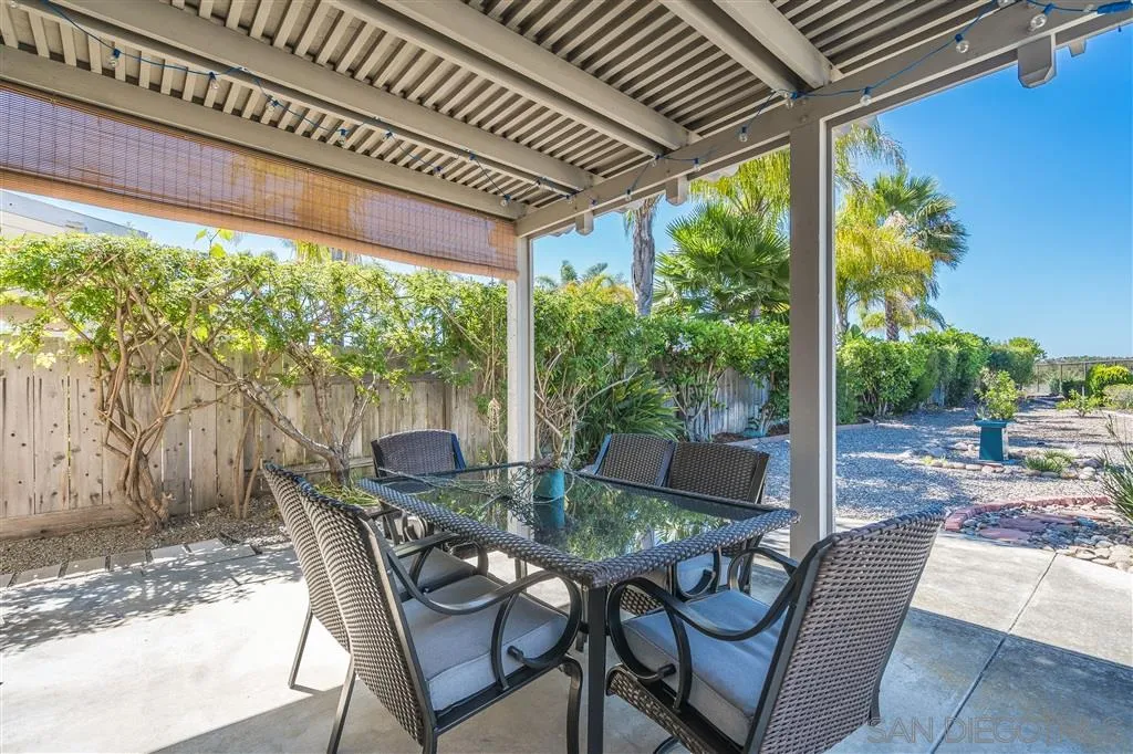 7570 Windy Ridge Road San Diego, CA 92126 - Photo 22 of 25 a view of an outdoor dining space with a table and chairs