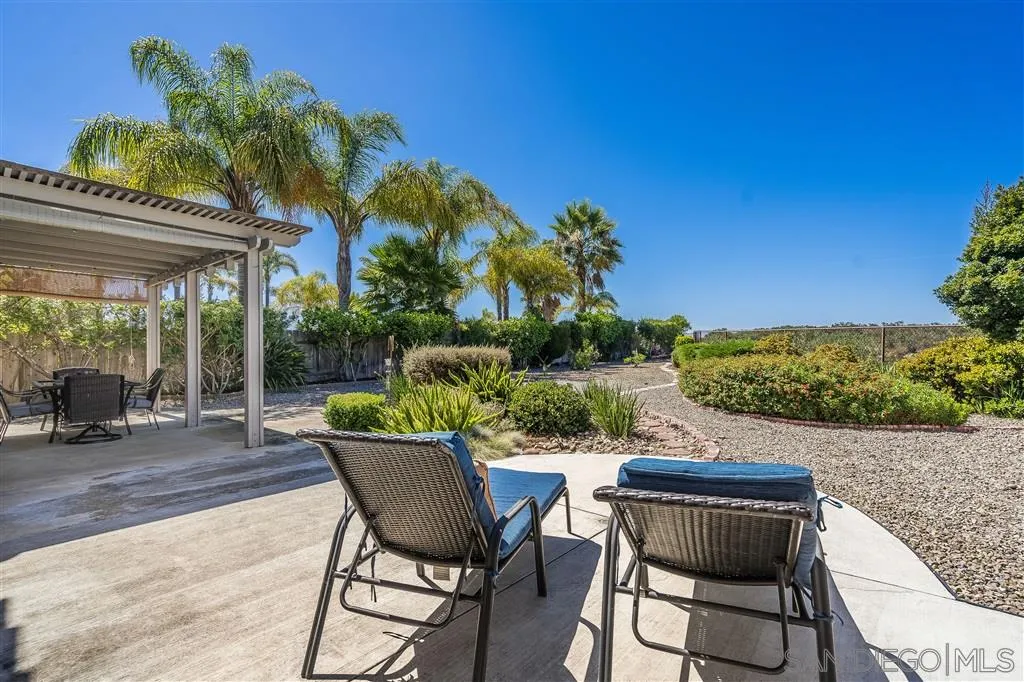 7570 Windy Ridge Road San Diego, CA 92126 - Photo 24 of 25 a patio with a table and chairs and potted plants