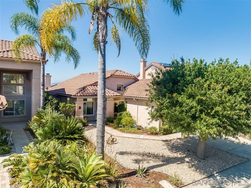 7570 Windy Ridge Road San Diego, CA 92126 - Photo 5 of 25 a front view of a house with a yard and a garage