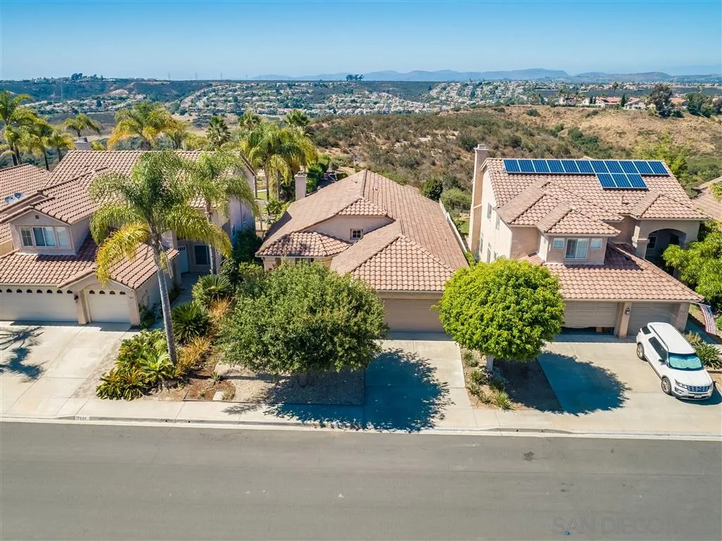 7570 Windy Ridge Road San Diego, CA 92126 - Photo 6 of 25 an aerial view of a house with a yard and ocean view