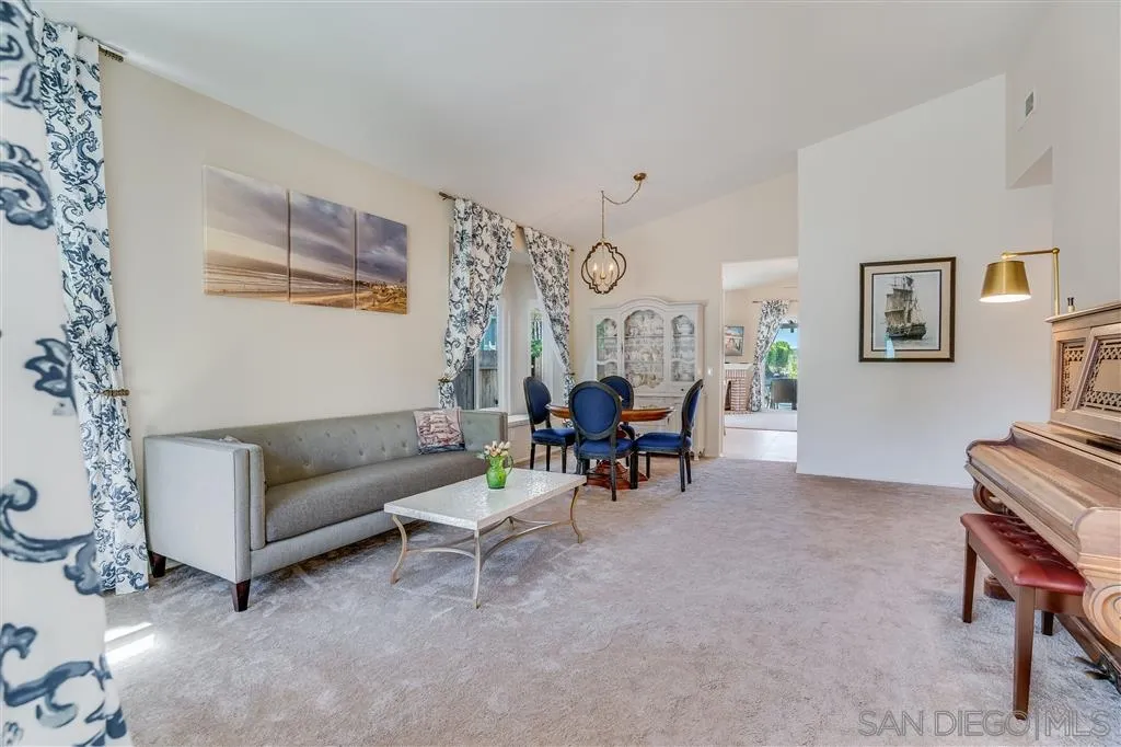 7570 Windy Ridge Road San Diego, CA 92126 - Photo 8 of 25 a living room with furniture and a dining table