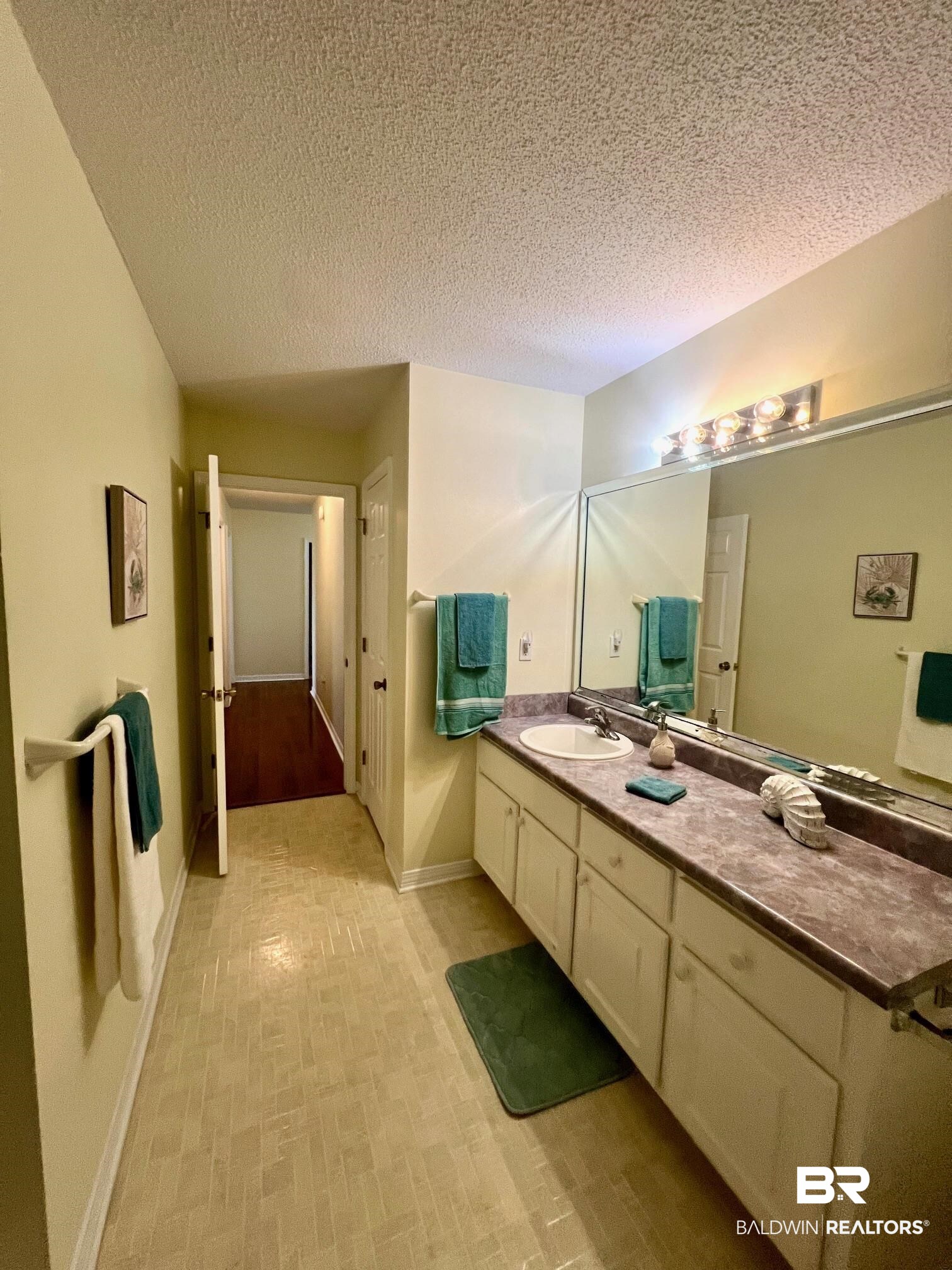 2204 Club House Drive Lillian, AL 36549 - Photo 16 of 38 Bathroom with vanity and a textured ceiling