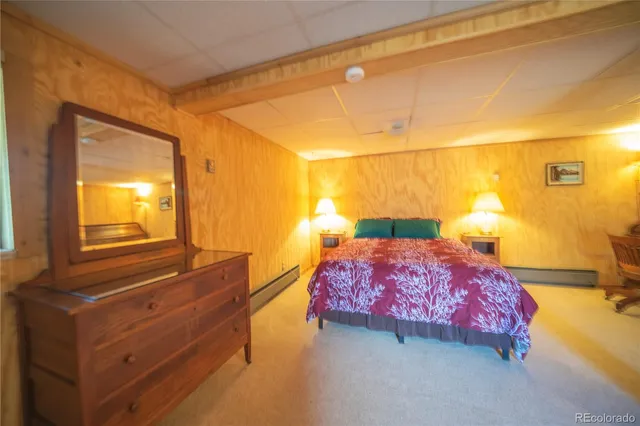 a bedroom with a bed and lamp with window