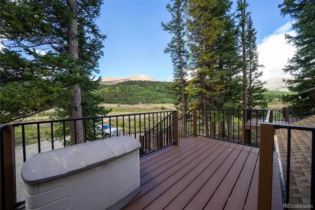 a balcony with wooden floor and fence