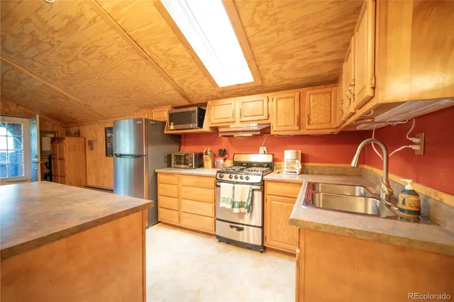 a kitchen with stainless steel appliances granite countertop a sink and cabinets