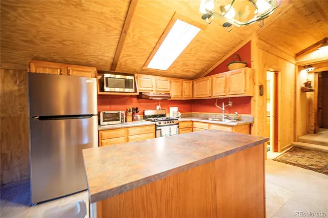 a view of a kitchen with a refrigerator and a microwave
