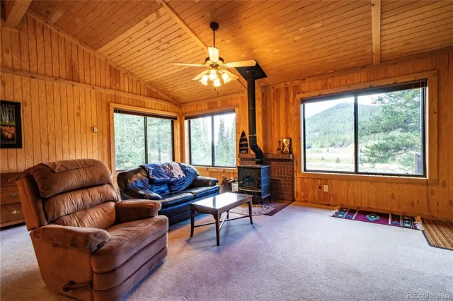 a living room with furniture a ceiling fan and a window