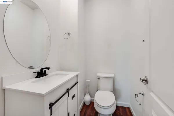 a bathroom with a sink a toilet and a mirror