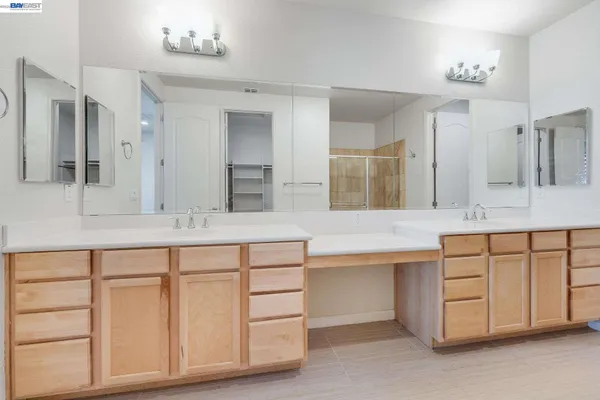a bathroom with a sink vanity and mirror
