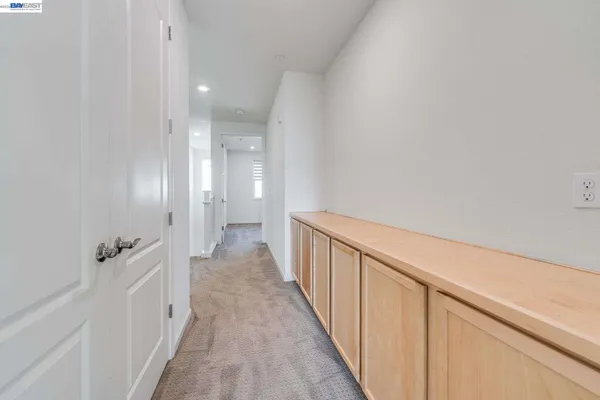 a view of a hallway with wooden floor and closet