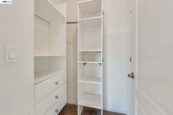 a bathroom with a closet and mirror