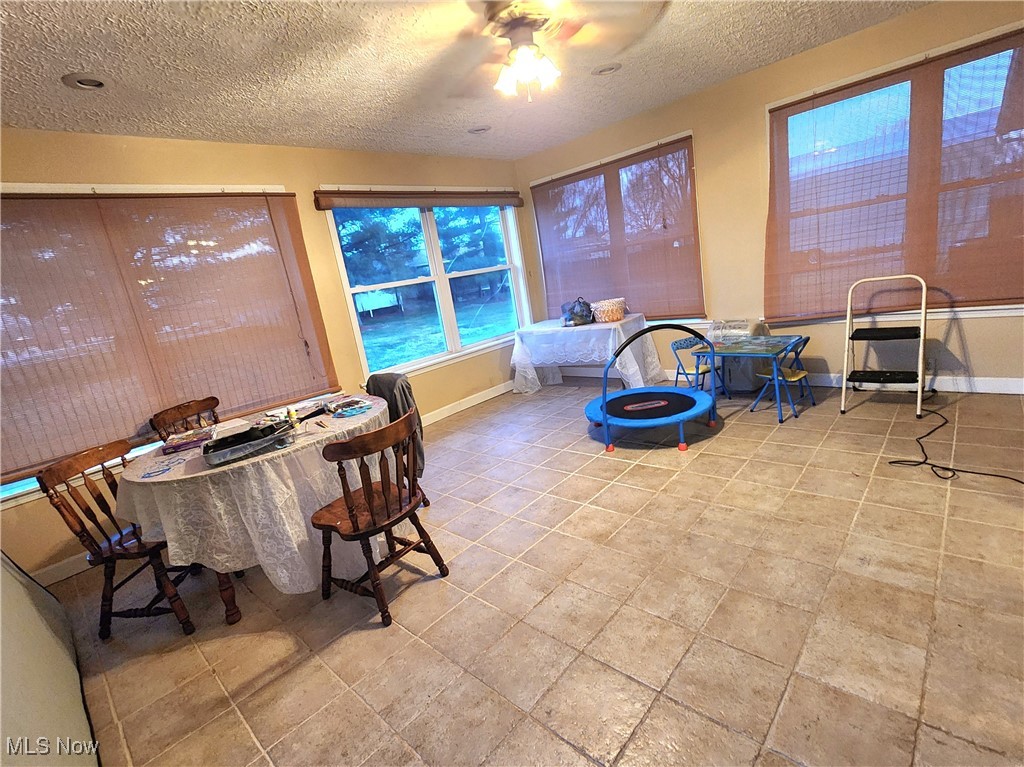 6280 Virginia Road Nashport, OH 43830 - Photo 6 of 14 Dining room featuring a textured ceiling and a ceiling fan