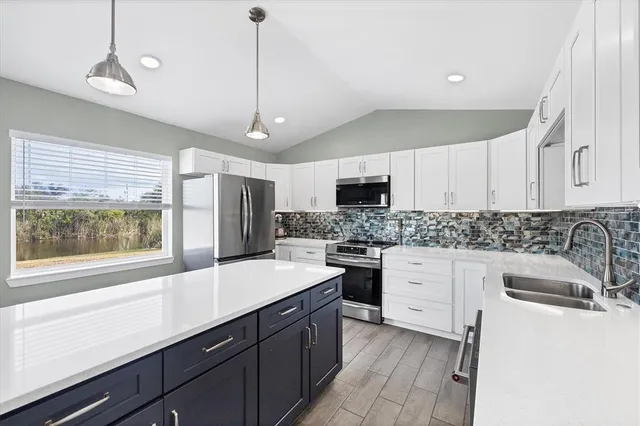 a kitchen with a sink stove and microwave