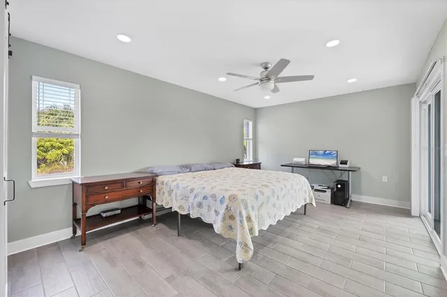 a bedroom with a large bed and a window