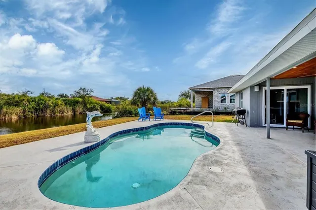 a view of a house with swimming pool and porch