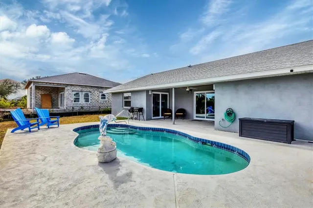 a view of a swimming pool with chairs