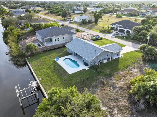 an aerial view of residential houses with outdoor space