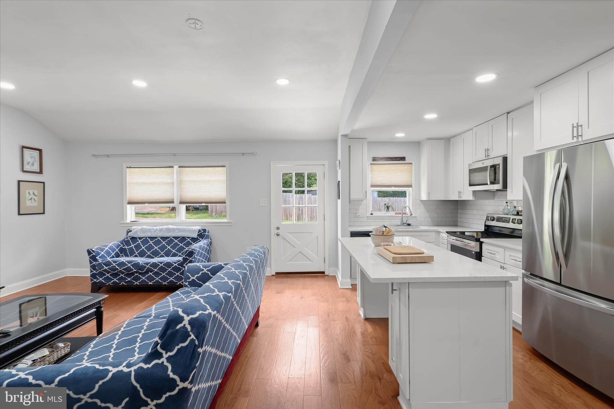 14213 Longnecker Road Reisterstown, MD 21136 - Photo 6 of 44 a kitchen with stainless steel appliances granite countertop a refrigerator a sink dishwasher a stove and a refrigerator with wooden floor