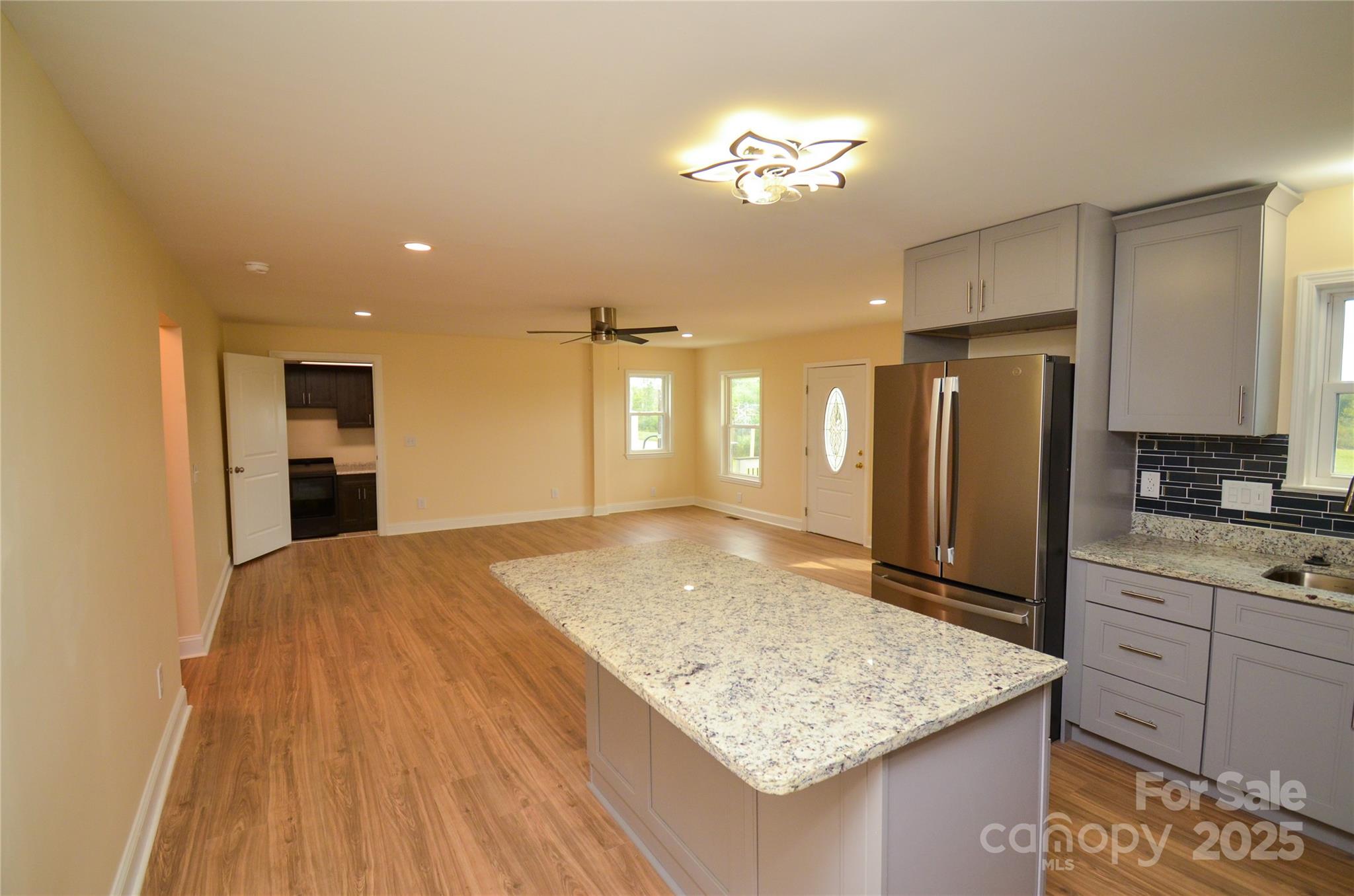 907 Carpenters Grove Church Road Lawndale, NC 28090 - Photo 12 of 33 a view of kitchen island a sink wooden floor and a refrigerator