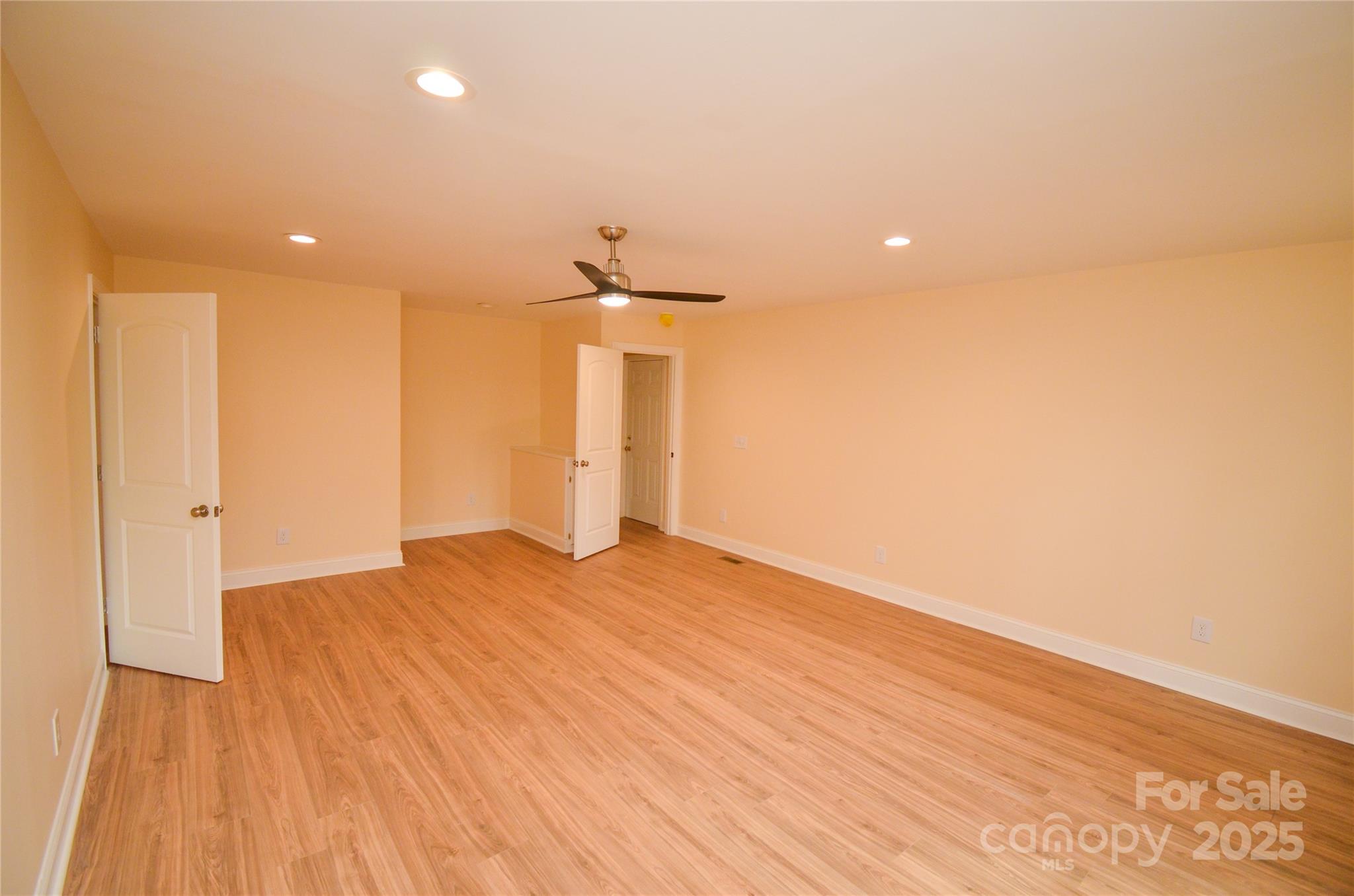 907 Carpenters Grove Church Road Lawndale, NC 28090 - Photo 22 of 33 a view of empty room with wooden floor and fan