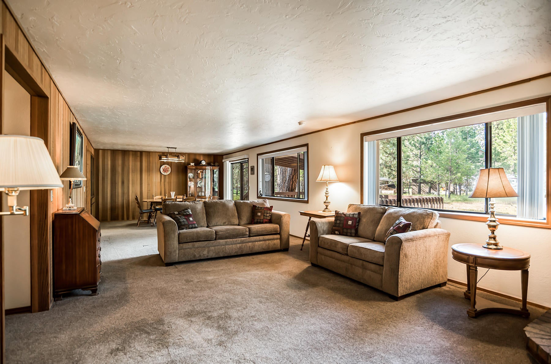 14557 Crossroads Loop Sisters, OR 97759 - Photo 14 of 25 Living room with clear cedar, large bright windows. Newer carpet and paint in this room
