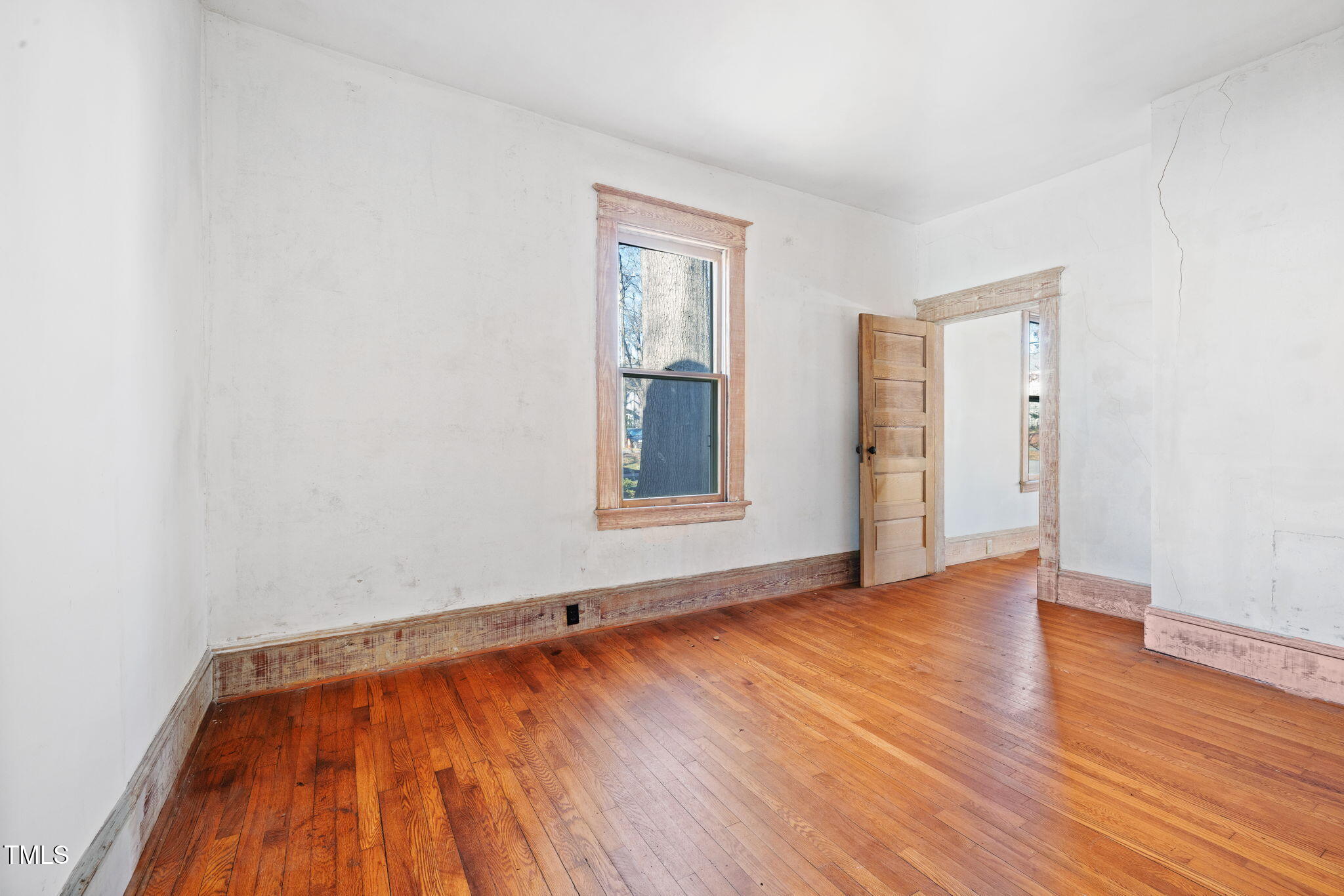 520 Polk Street Raleigh, NC 27604 - Photo 18 of 36 a view of an empty room with wooden floor and a window